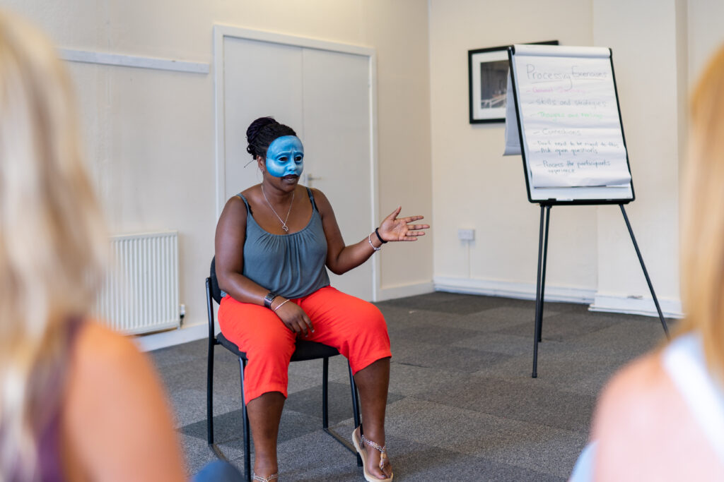 Practitioner, Liz, delivers a session in mask