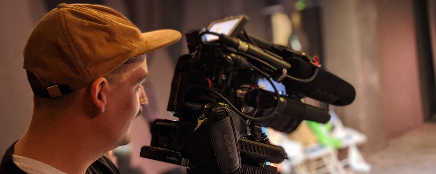 A filmmaker holds his camera