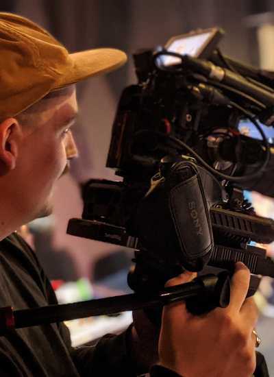 A filmmaker holds his camera