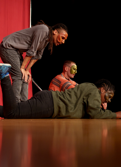 Actors on stage in mask