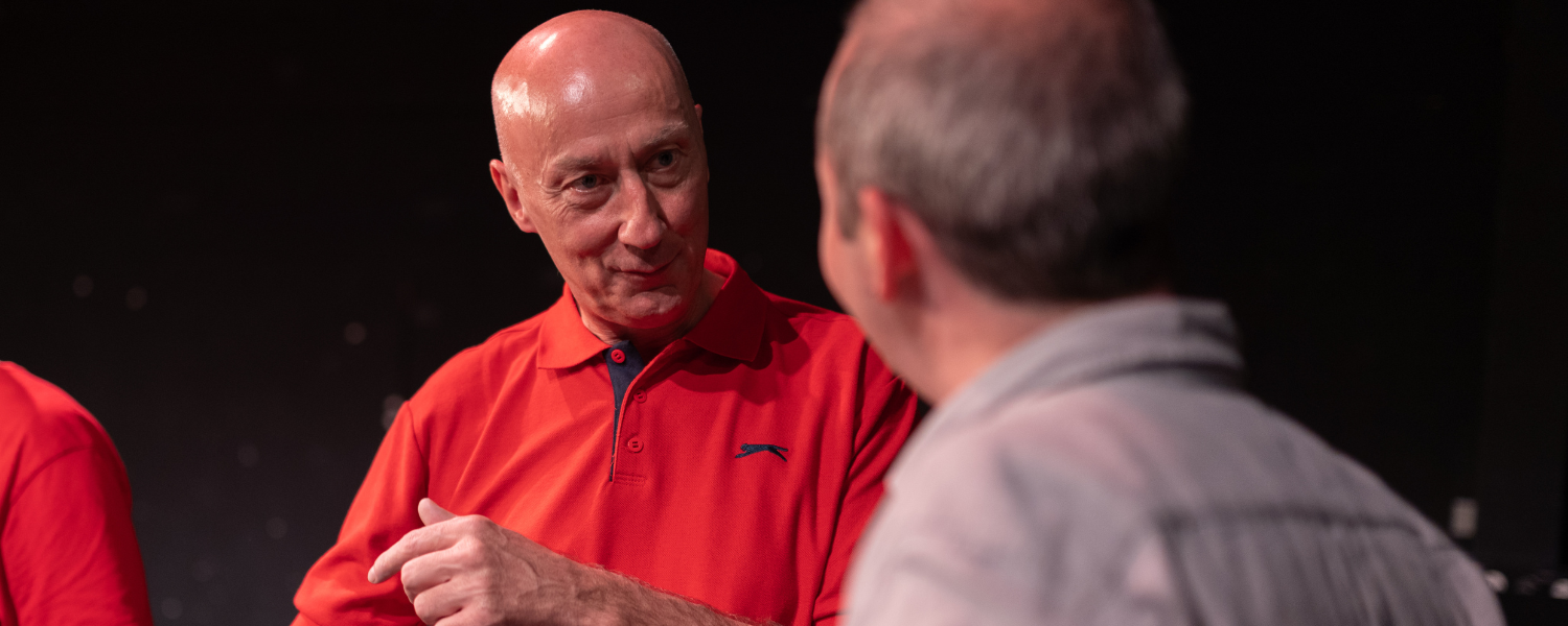 Shay speaks to an audience member