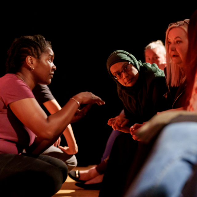 Senior Practitioner, Liz, talks to the audience during a performance