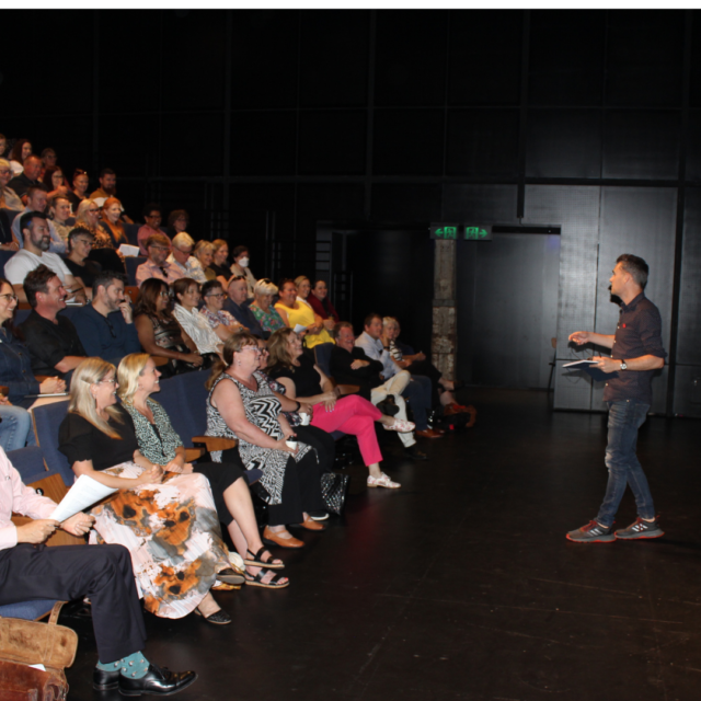 Andy delivers a talk at a symposium