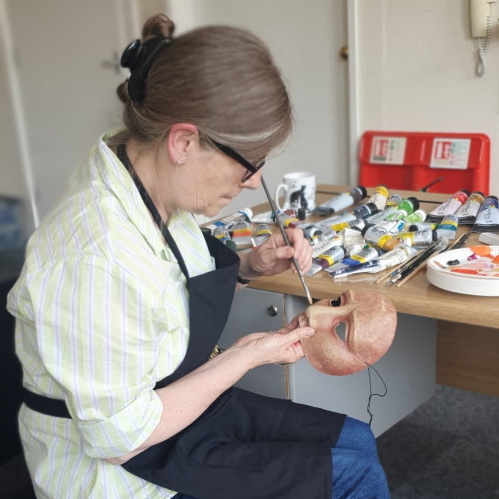 Sally Brookes painting Geese masks