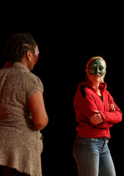 Two Geese practitioners, Liz and Emma, perform Conflict Zone in half masks